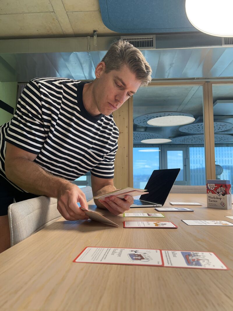 Nick preparing workshop cards at a table at JobCloud