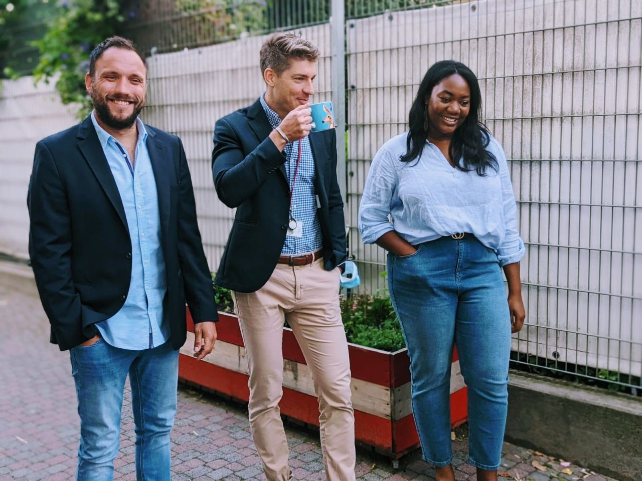 Nick walking outdoors with two colleagues